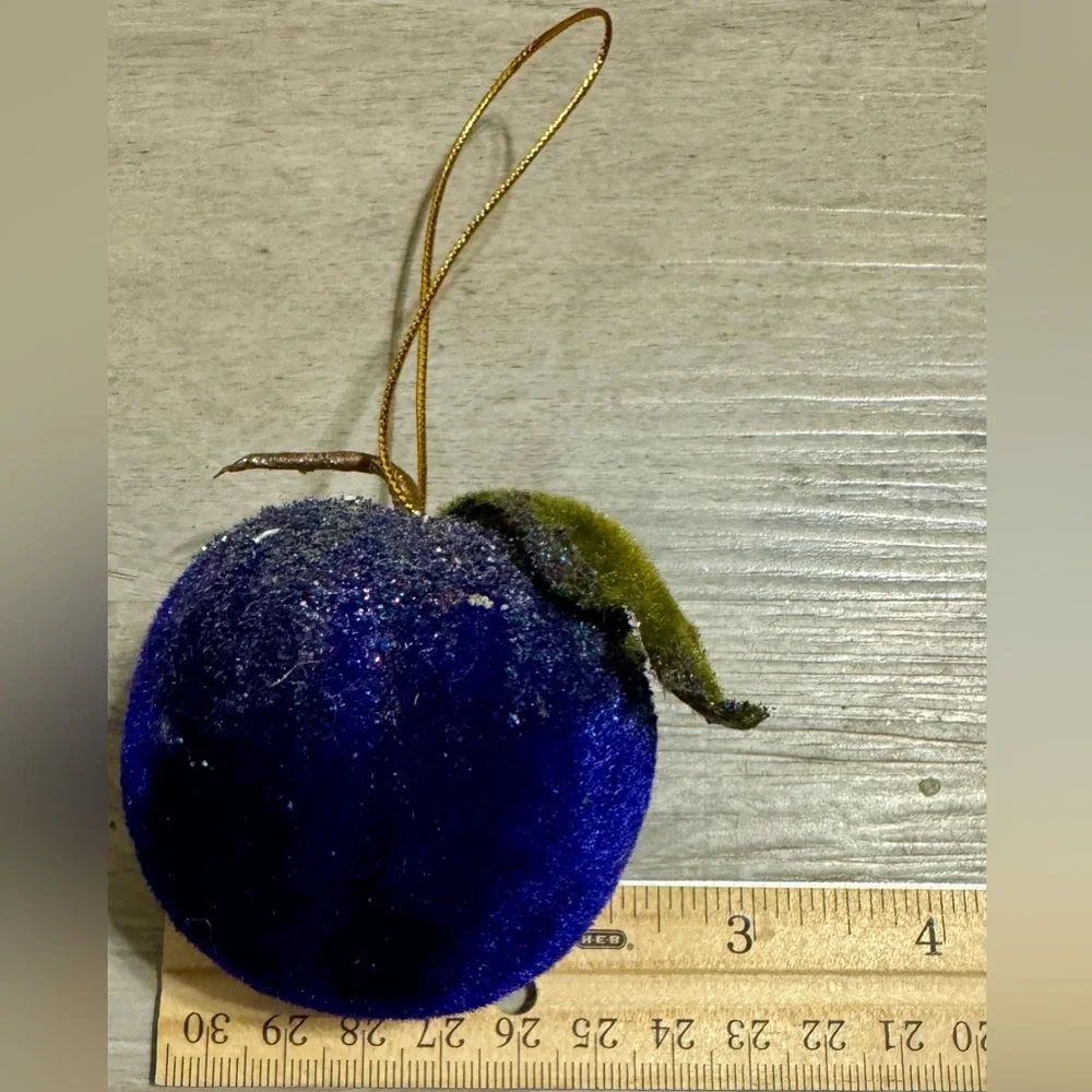 Christmas tree ornament. A plum-shaped ornament covered in glitter. The ornament